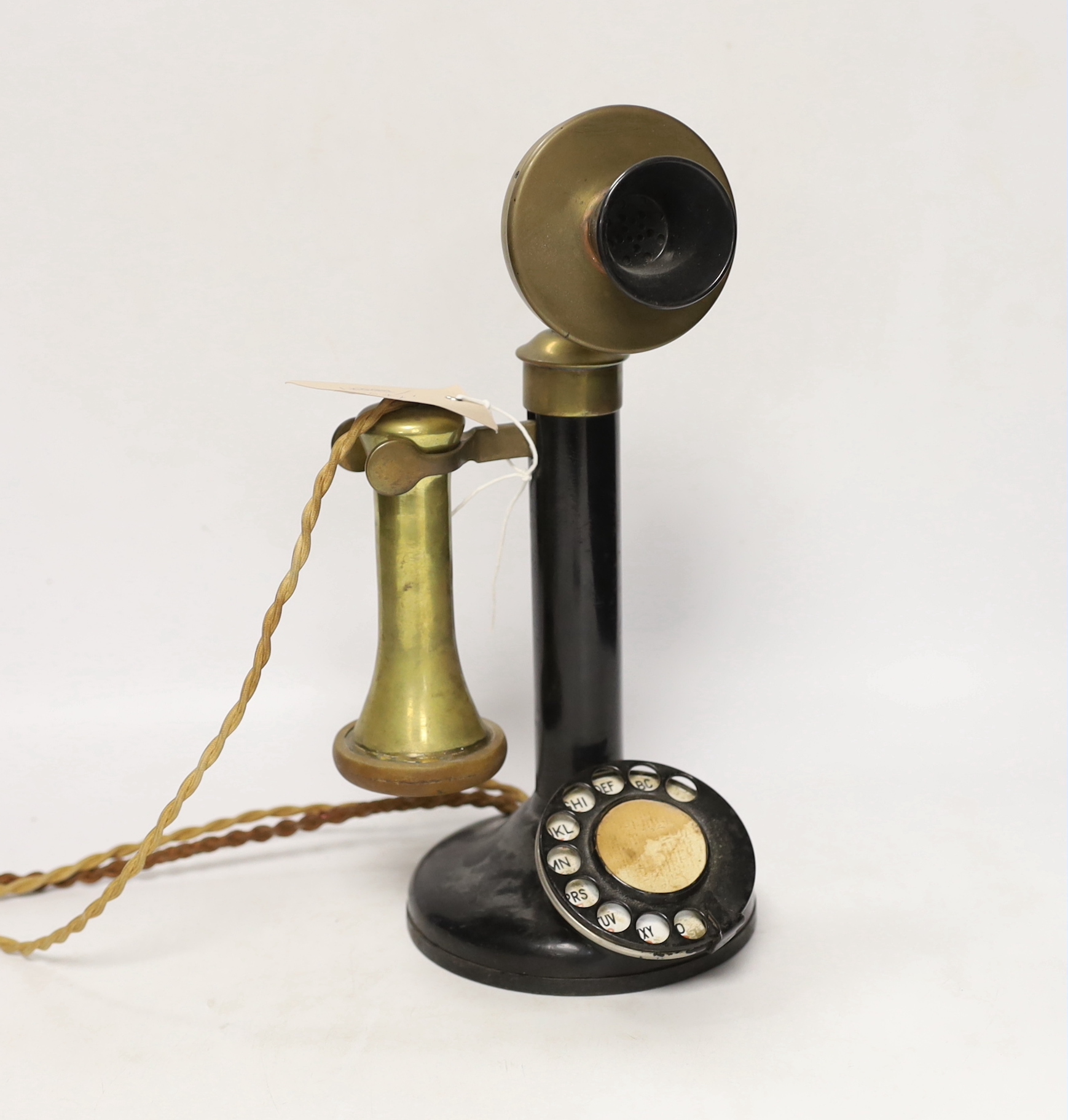 A vintage stick telephone, 32cm high